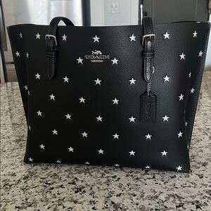 Coach Mollie Tote Black with Silver Star Print- In good condition.
